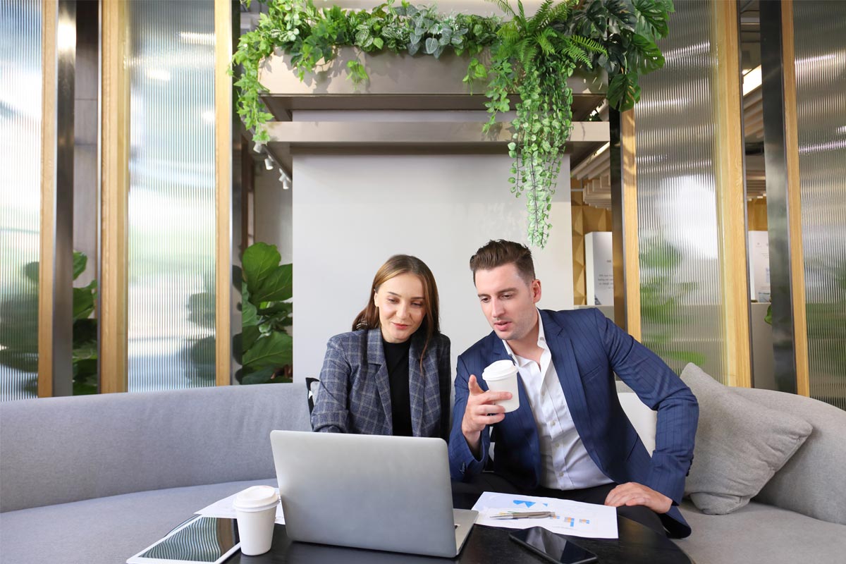 Two employees in a sustainably refurbished office, London