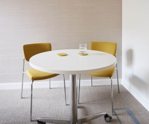 breakout table with two upholstered mustard coloured seats