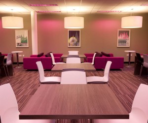 breakout area with soft seating and dining tables and chairs
