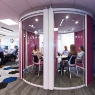 Pink round meeting pod with glass door and internal partition